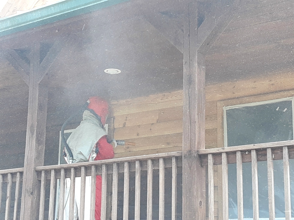Media blasting log home by the LogDoctors Log Home Repair 