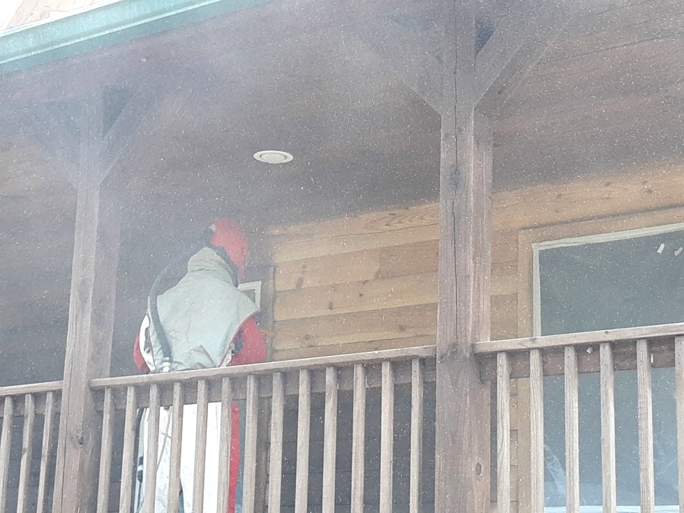 Media blasting log home by the LogDoctors Log Home Repair 